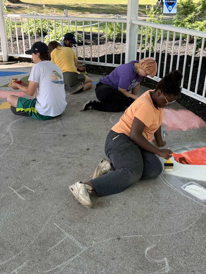 Volunteers painting the geometric fields